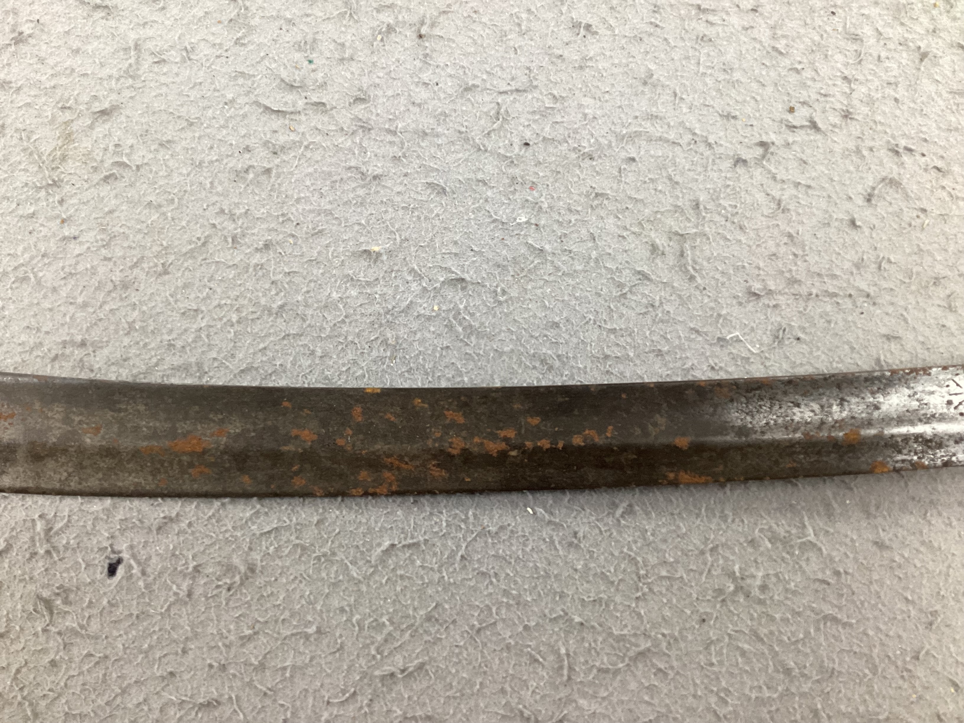 An English hangar, mid 17th century, curved fullered blade engraved with spurious date 1535 and running wolf mark, iron guard slightly reduced and swollen pommel, spirally carved and chequered bone grip, blade 67.5cm